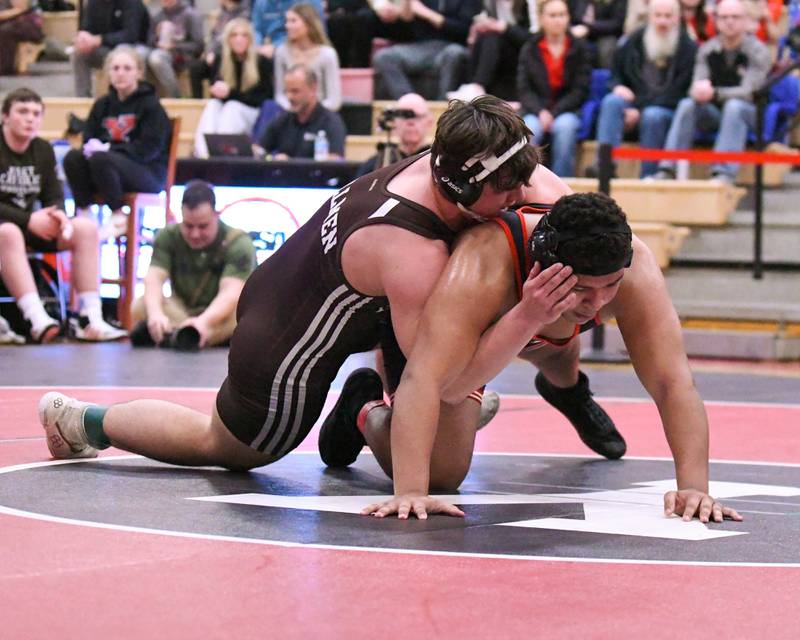 Derrick Pomatto of Joliet Catholic Academy, left, tries to control Yorkville’s Xavion Ulloa during the 285-weight class in the regional team match up on Tuesday Feb. 25, 2025, held at Yorkville High School.