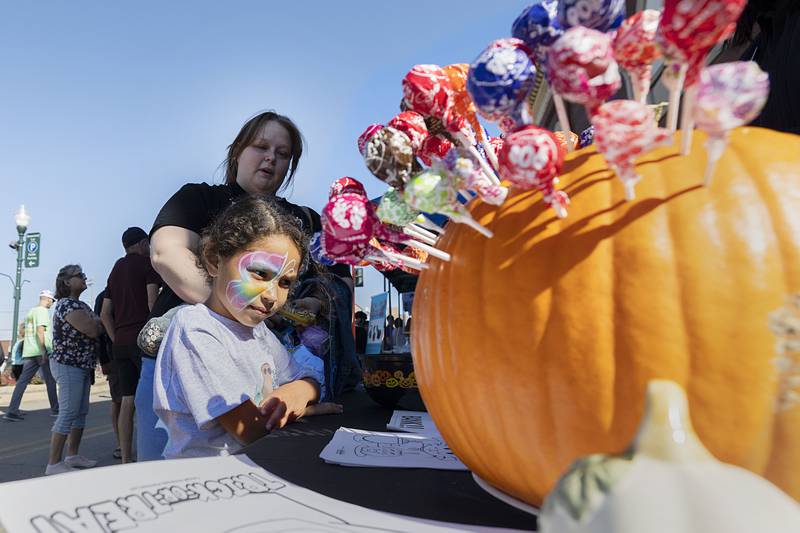 Layla Johnson, 5, of Dixon draws a sucker to see if she wins a prize from the Thrivent Financial booth Saturday, Oct. 22, 2022 during Dixon’s Scarecrow Fest.