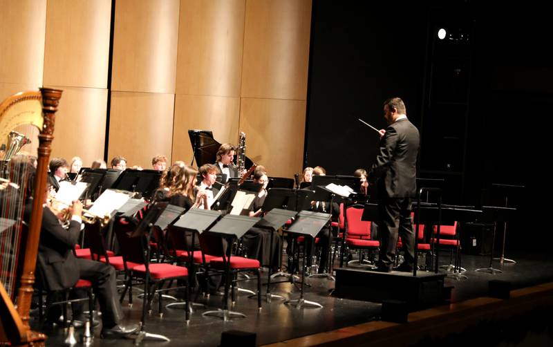 Batavia High School Band Director Chris Owen leads the Batavia High School Wind Ensemble on Wednesday, Dec. 18, 2024 at the Batavia Fine Arts Centre. The concert included a performance by the Inagakuen Sogo High School Wind Orchestra from Japan.