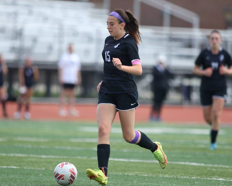 Downers Grove North's Katelyn Hennelly (15) advances the ball during soccer match between Downers Grove North at Downers Grove South.  May 6, 2023.