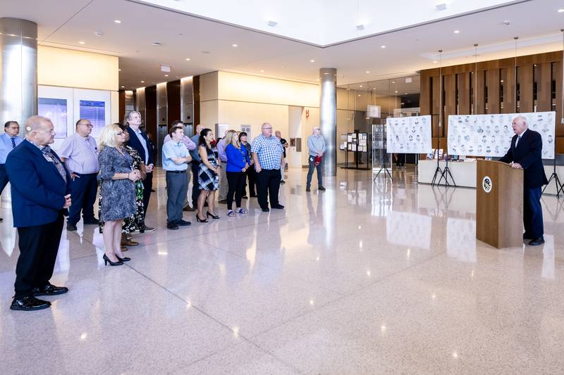 Attendees listen as Former Governor Pat Quinn shares remarks during the opening of the 'Portrait of a Soldier' exhibit at the Will County Courthouse in Joliet, Illinois on Sept. 11, 2025.