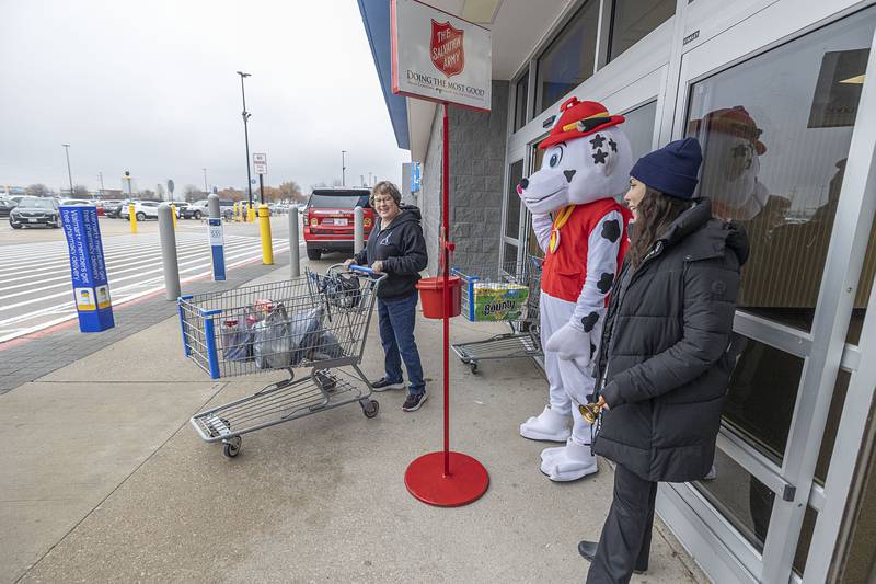 Sterling fire’s Angelica Dornes (right) and Marshal thank donors Thursday, Nov. 20, 2025, outside of the Sterling Walmart. The police and fire departments went head to head in donation collections to help benefit the Salvation Army.