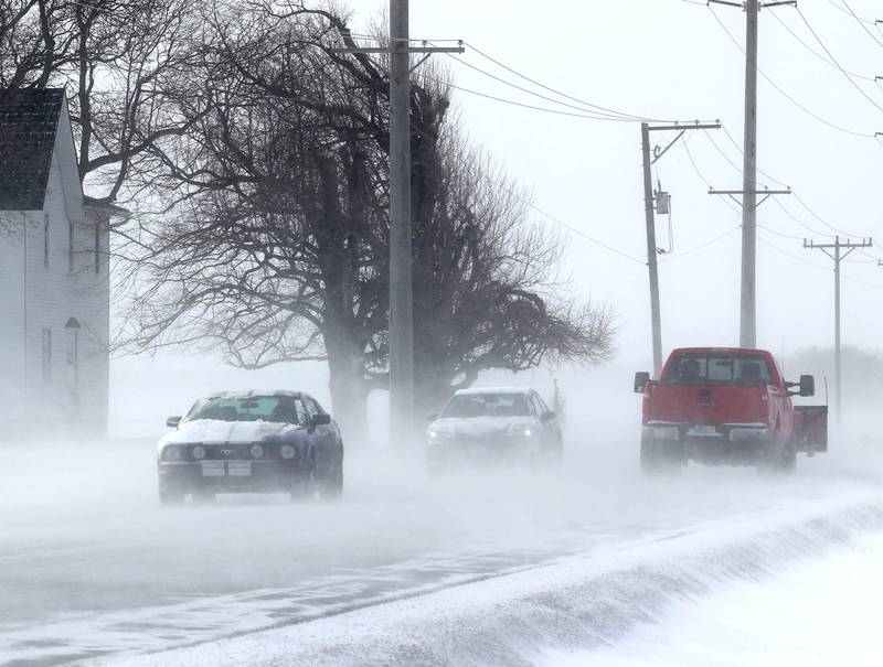 Vehicles travel through blowing snow Monday, March 16, 2026, on Somonauk Road just south of Hinckley. A March snowfall covered DeKalb County in about six inches of the white stuff Sunday night into Monday.