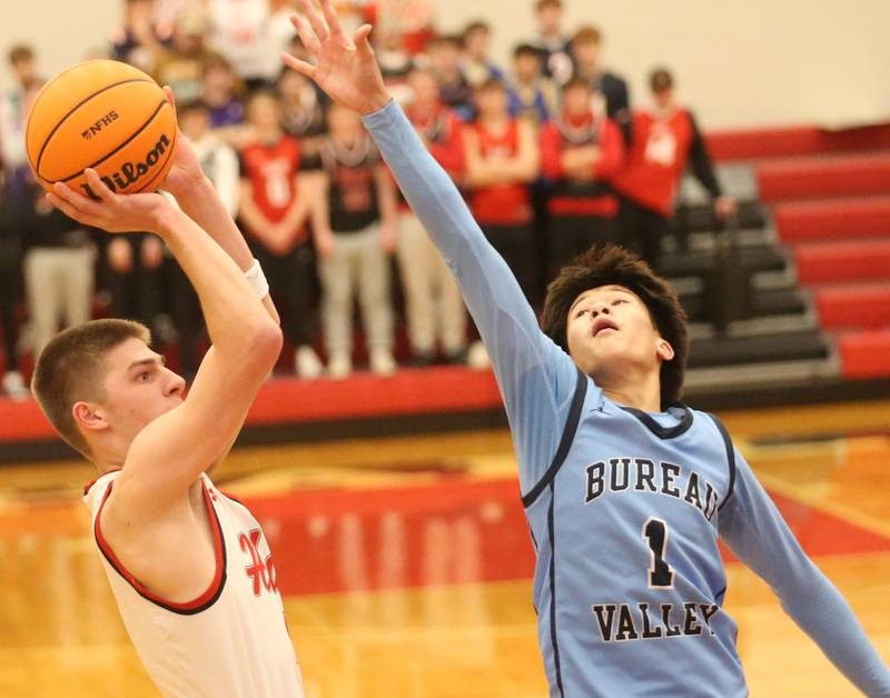 Hall's Luke Bryant lets go of a jump shot over Bureau Valley's Carter Chhim on Wednesday, Jan. 28, 2026 at Hall High School.