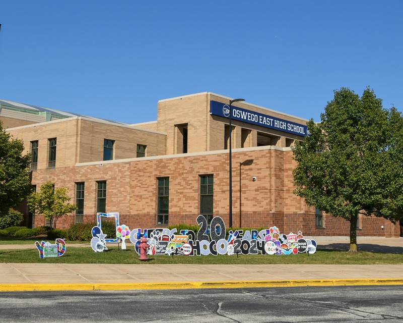Yards signs that read “cheers to 20 years” and HOCO 2024” among others saying sit outside the entrance of Oswego East High School on Friday Oct. 4, 2024, as they celebrate 20 years since the school has opened during homecoming week.