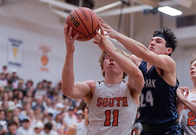 Wheaton Warrenville South's Colin Moore (11) and Lake Park's Dennasio LaGioia (24) work for the rebound during a game on Saturday, Jan. 7, 2023.