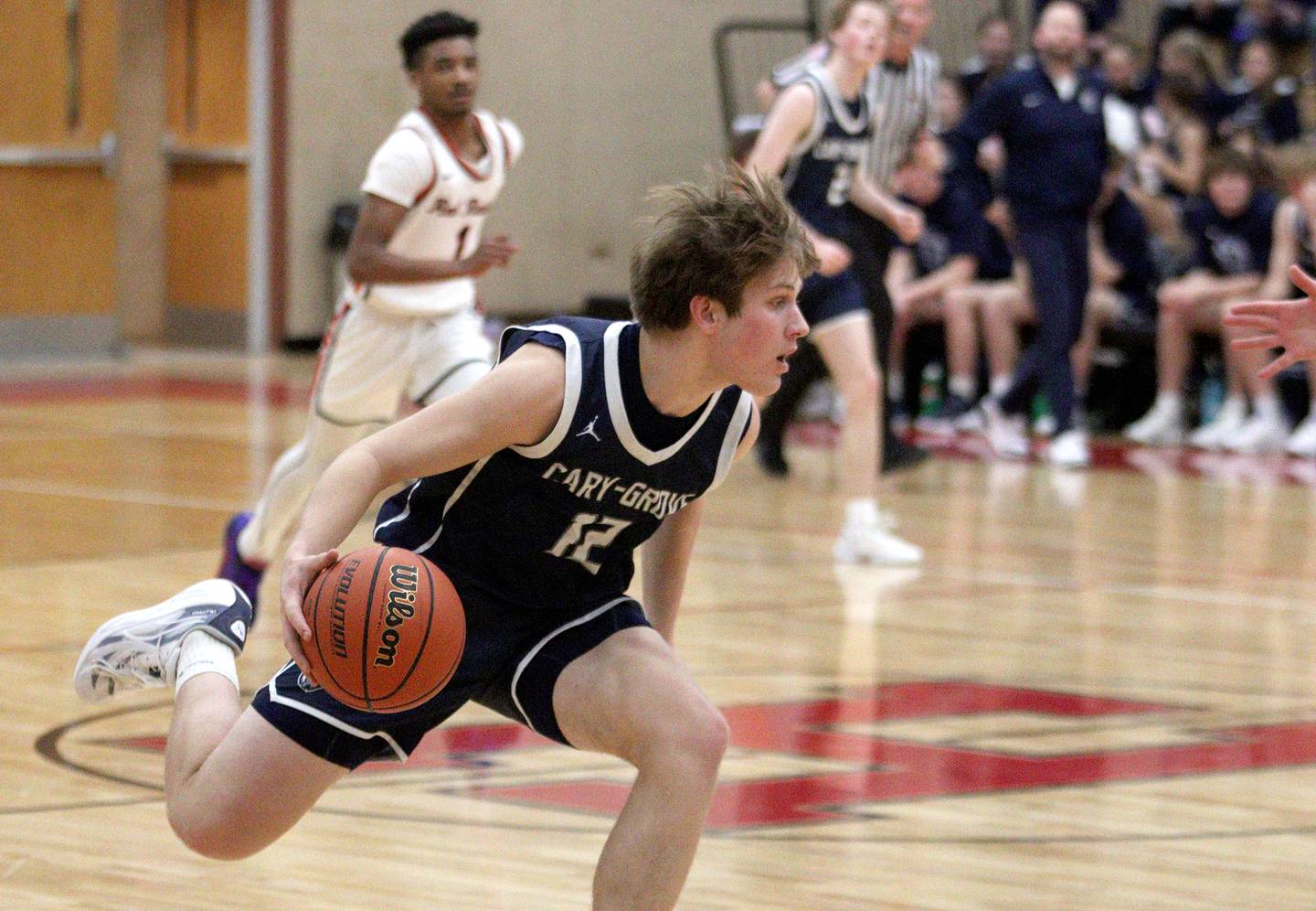 Cary-Grove’s Jake Hornok moves the ball in varsity boys basketball at Huntley Friday.