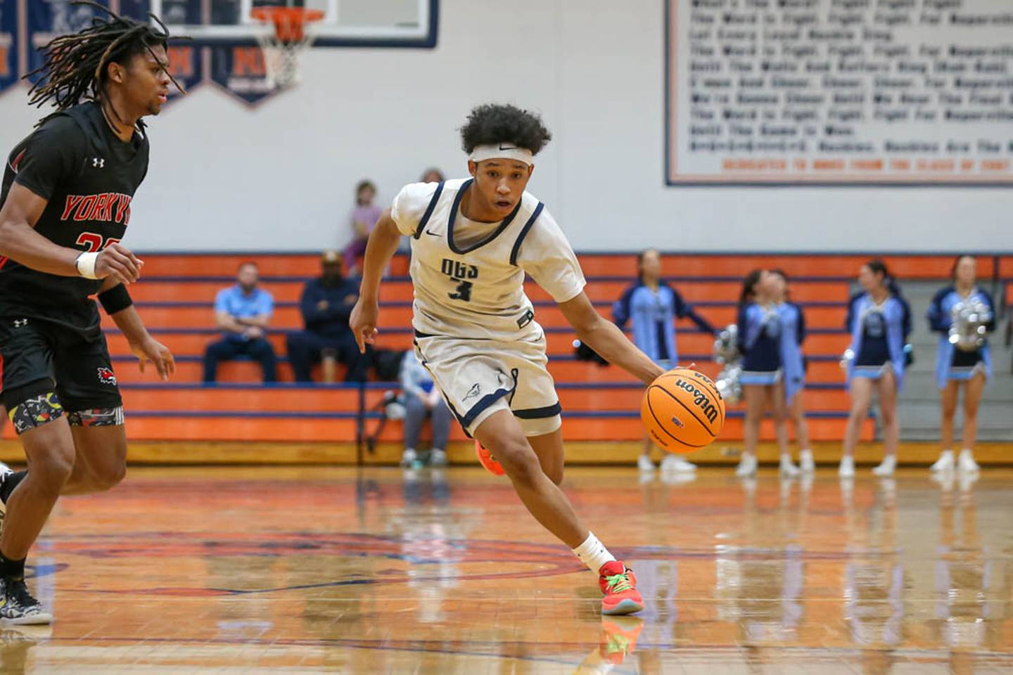 Downers Grove South's (3) Adam Flowers drives past the defense of Yorkville's Braydon Porter (22) during their Class 4A Naperville North Regional final basketball game between Yorkville at Downers Grove South, Feb 27, 2026 in Naperville.
