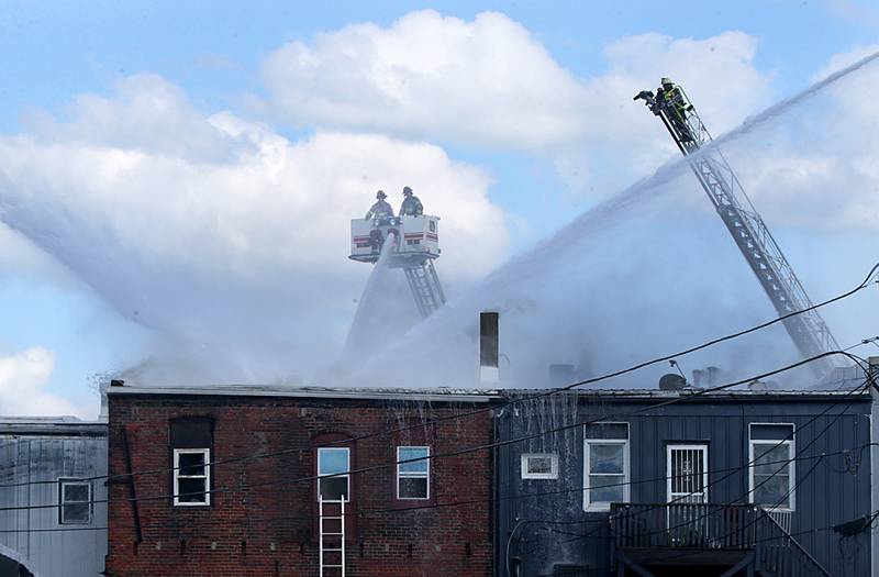 Firefighters spray water on an apartment fire in the 800 block of Main Street on Monday, Aug. 22, 2022 in Mendota.