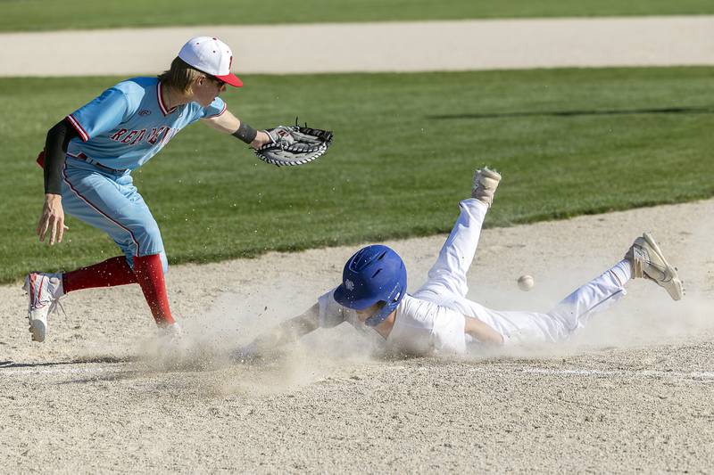 Newman’s Joe Oswalt dives back to first on a pickoff attempt against Hall Monday, April 15, 2024 at Newman High School.