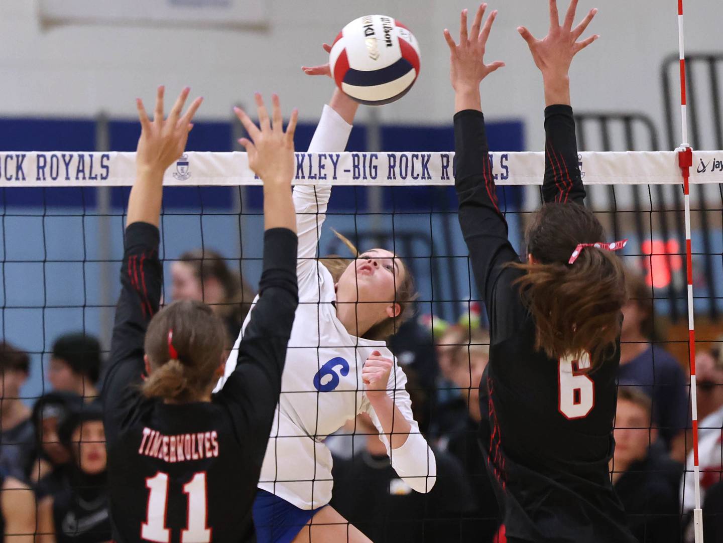 Hinckley-Big Rock's Courtlyn Brockway spikes the ball between Indian Creek's Ellie Bend (left) and Isabella Turner during their match Tuesday, Sept. 24, 2024, at Hinckley-Big Rock High School.