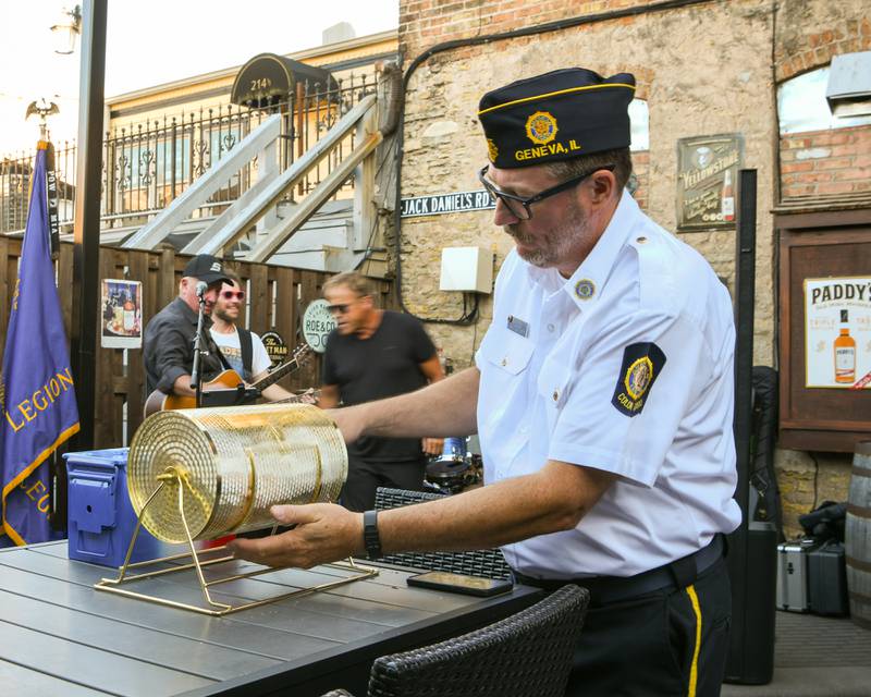 Mike Ferrari, commander of the Geneva American Legion post, spins the 50/50 raffle tickets during a fundraiser for the post Thursday Aug. 21, 2025.