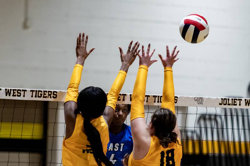 Lincoln-Way East's Klarke Mosby spikes against Joliet West during a Varsity Volleyball match at Joliet West on Aug. 26, 2025.