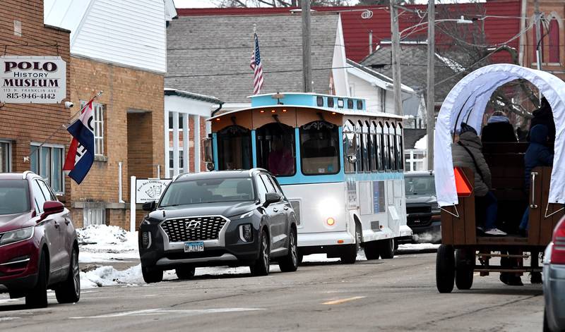 Polo's Christmas Festival included Historical Tour trolley rides and Mane Street Horse and Wagon Rides on Saturday, Dec. 6, 2025. Here, the two pass on Franklin Avenue by the Polo History Museum.