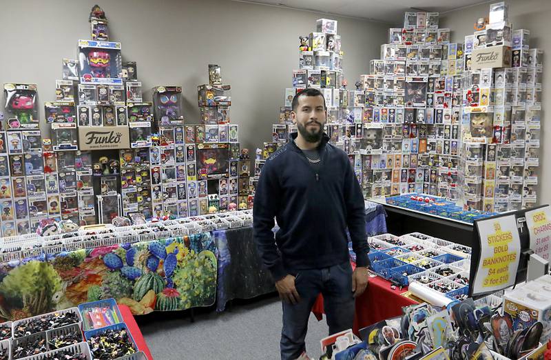 Andrew Rios, the owner of Andy’s World, on Wednesday, Feb. 5, 2025, inside his store in the Woodstock Square Mall. The store sells Funkos, charms for  CR0CS, metal pins, and posters.