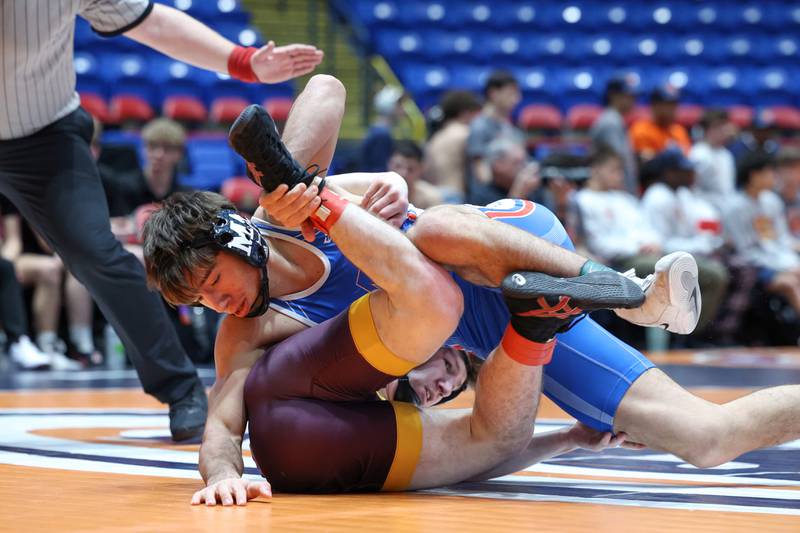 Marmion Academy's Demetrios Carrera, top, wrestles Montini's Jeremy Huf during Marmion Academy's victory over Montini in the IHSA Class 3A Dual Team State championship on Saturday, Feb. 28, 2026.