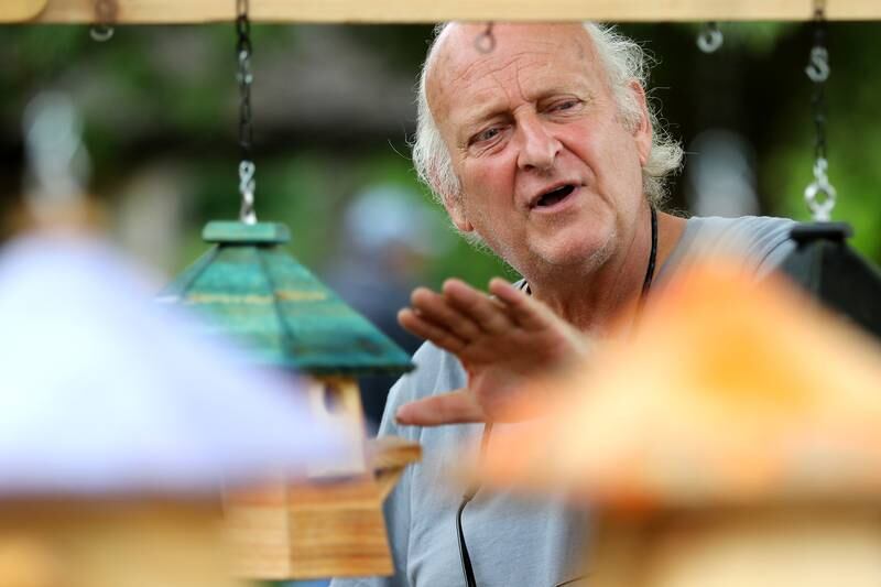 Mike McIntyre of Little Layla's Cool Birdhouses shows potential customers his birdhouses at the farmers market outside the Dole Mansion on Sunday, June 20, 2021, in Crystal Lake.  The farmers market is new to the Dole this year, having never had one there before this month.