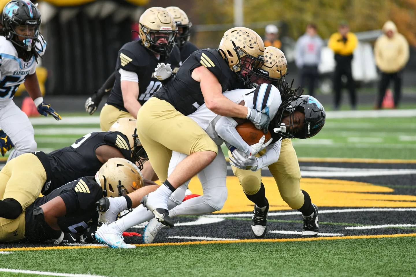 Kankakee's Cedric Terrell III is tackled by a host of Richards defenders during an IHSA Class 6A Playoff quarterfinal game at Richards Saturday, Nov. 16, 2024.