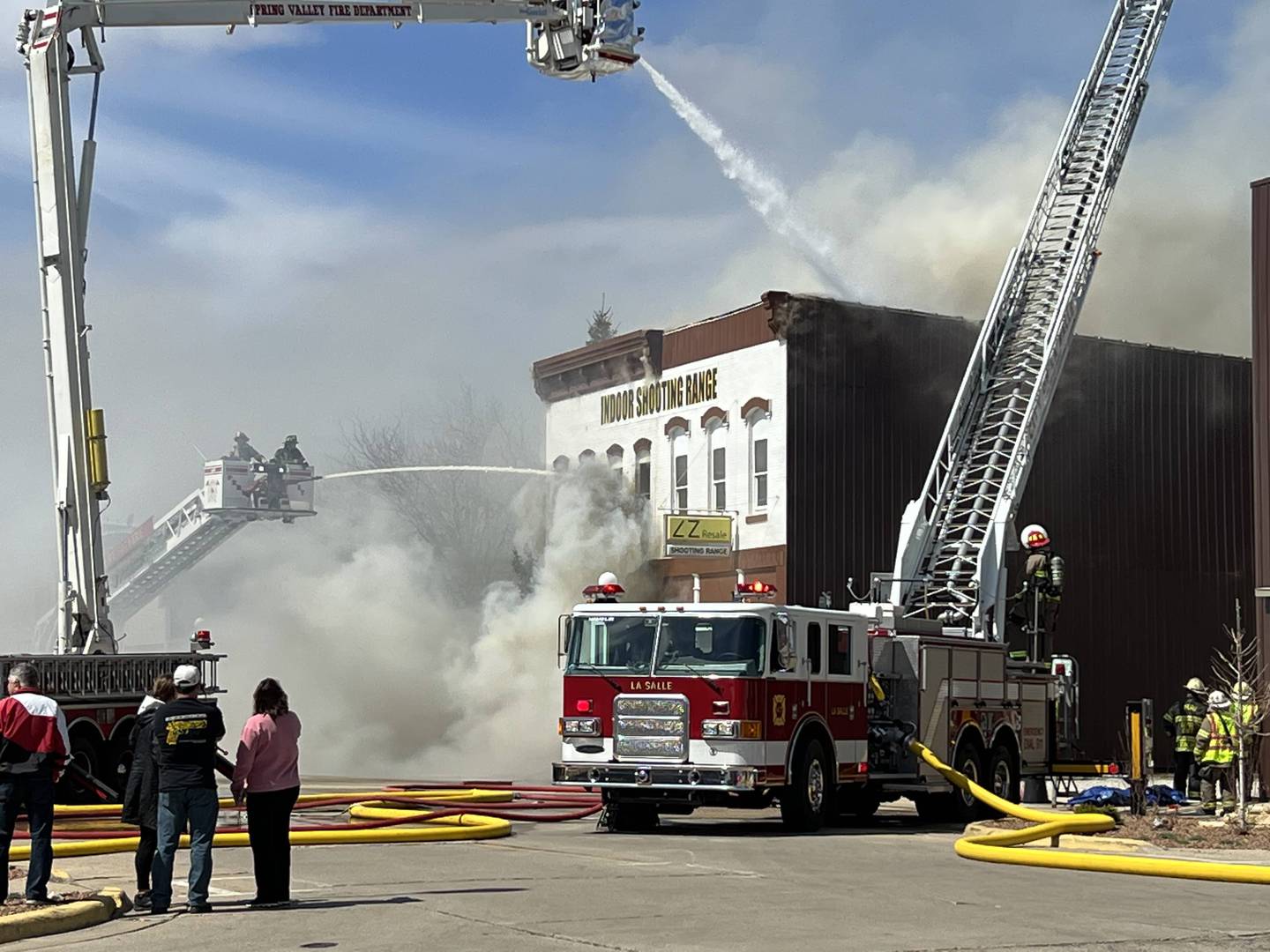 Aerial fire trucks were utilized Sunday, April 2, 2023, to spray a downtown storefront in Spring Valley that was a total loss from an afternoon fire.