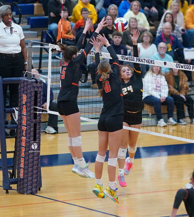 Joliet West's Natalia Harris (24) plays the ball at the net against Lincoln-Way West's Caroline Smith (5) and Lily Goyer (6) during a class 4A Oswego Sectional semifinal match at Oswego High School on Monday, Oct. 30, 2023.