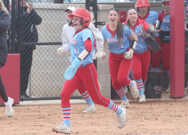 Ottawa's Rylee Harsted races home as teammates pour out of the dugout after Bobbi Snook blasts a two-run home run against L-P on Monday, April 21, 2025 at the L-P Athletic Complex in La Salle.