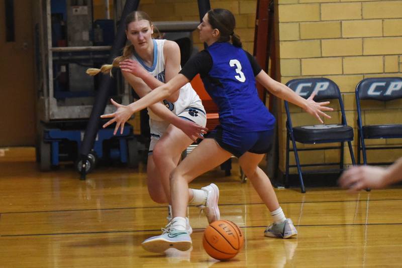Cissna Park's Annika Stadeli, left, makes a pass while Clifton Central's Emma Koch defends during a game at Cissna Park Wednesday, Feb. 4, 2026.