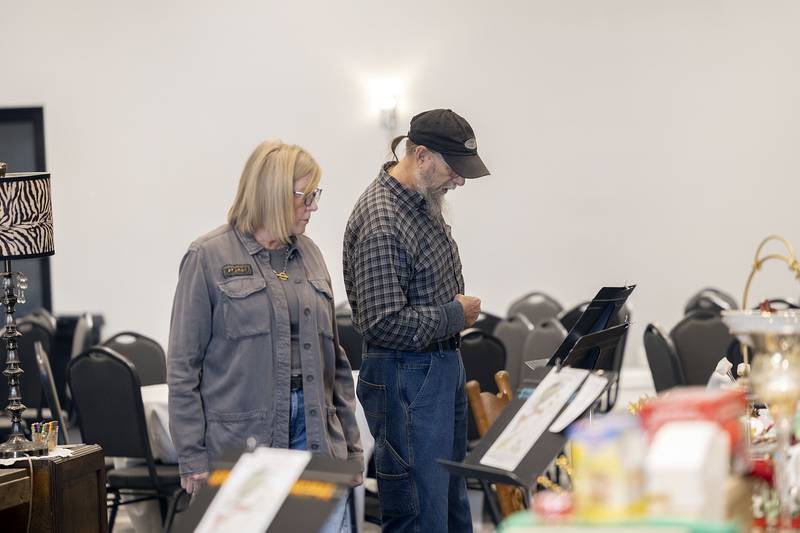 Cheryl and Bruce Frank check out the decorated trees and table settings Thursday, Nov. 13, 2025, at Rock River Hospice and Home Festival of Trees. The fundraiser features dozens of Christmas trees, unique place settings and fun decorations all up for bid. The event runs until Saturday at the McCormick Event Center in Rock Falls.