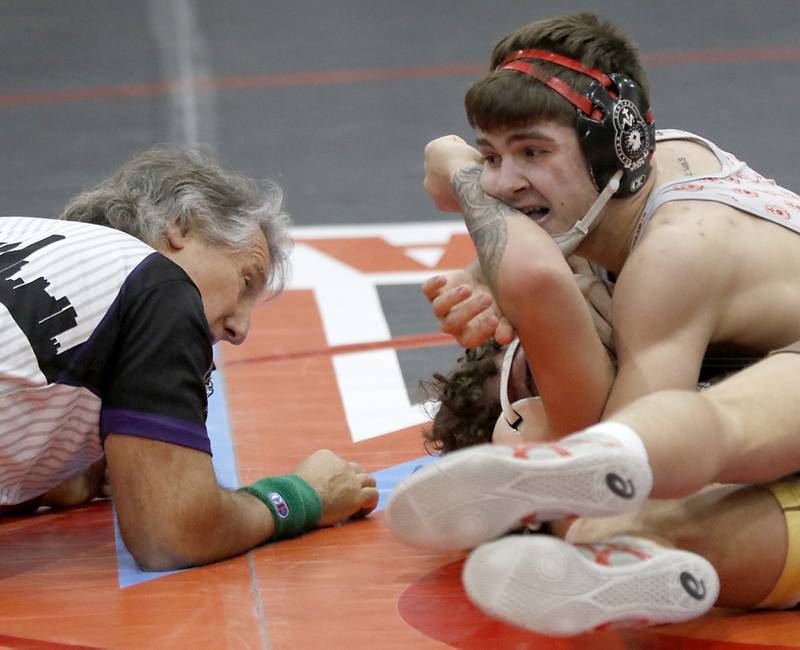 Marian Central's Vance Williams tries to pin Mt. Carmel's Jairo Acuna in their 150-pound match during a triangle wrestling meet on Saturday Jan. 11, 2025, between Marian Central, Joliet Catholic, and Mt. Carmel at Marian Central High School in Woodstock.