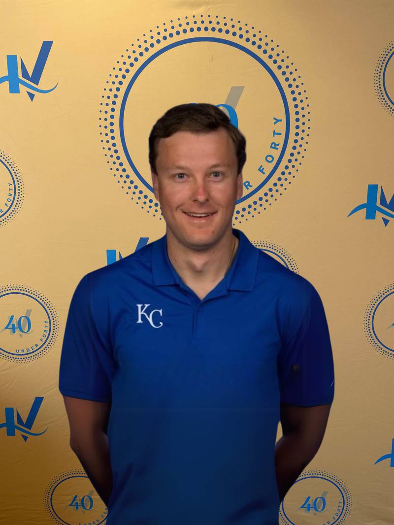 Brad Groleau poses for a photo underneath the 40 Under Forty backdrop.