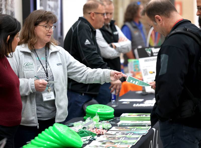 Vistors receive information from one of the booths Wednesday, Oct. 22, 2025, during Trades Exploration Day at DeKalb High School. The event hosted several companies and organizations that were offering information on opportunities in the trades.