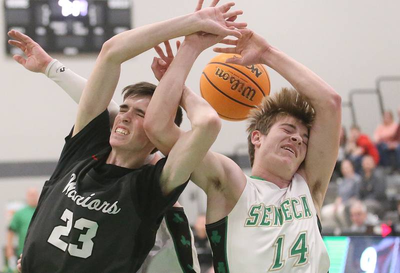 Woodland's Nick Plesko and Seneca's Cameron Shriey jump for a rebound on Friday, Feb. 14, 2025 at Seneca High School.