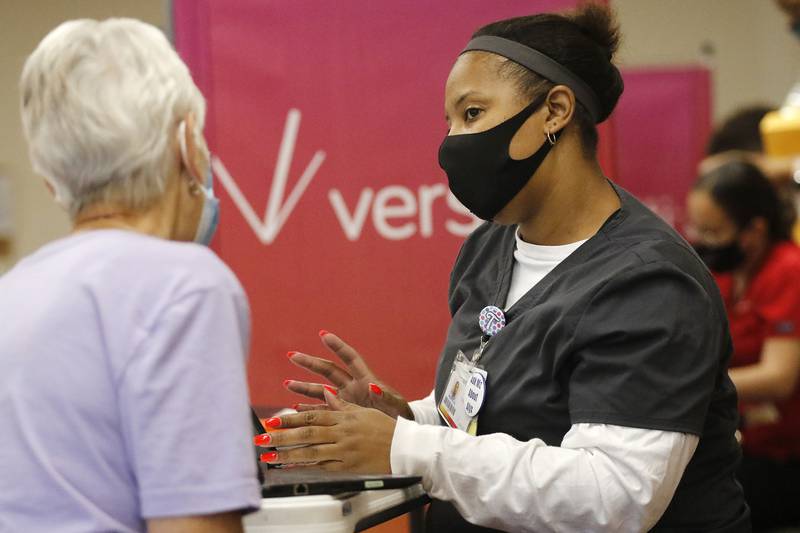 Versiti phlebotomist Tiffany Knox talks with blood donor Sue Dubs, of Richmond, during the Meet a Hero Be a Hero blood drive with AmeriCorps Seniors, Senior Service Associates, and Versiti at McHenry Senior Center on Thursday, Sept. 9, 2021 in McHenry.  The blood drive booked all 24 appointments and offered donors a chance to meet some first responders from the Johnsburg Police Department and McHenry Township Fire Protection District as a rememberance on the 20th anniversary of the terrorism attacks on Sept. 11, 2001.