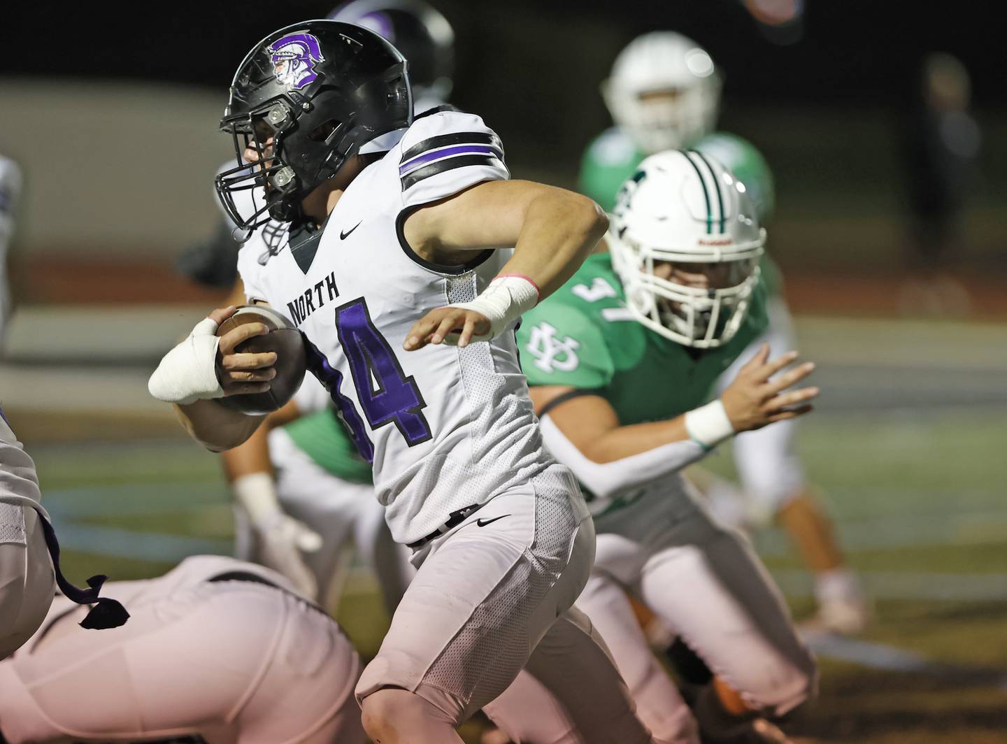 Downers Grove North's Jake Gregorio (34) runs during the varsity football game between Downers Grove North and York on Friday, Oct. 4, 2024 in Elmhurst.