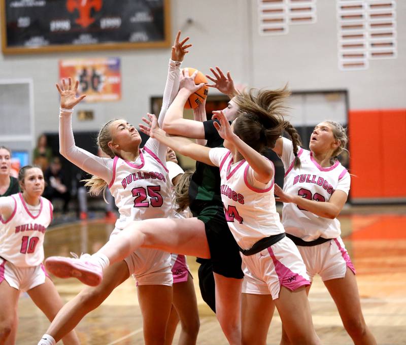 Glenbard West's Ellie Noble (center) pulls down a rebound between Batavia's Samantha Jansey and Batavia's Hallie Crane during the Class 4A St. Charles East Sectional final on Thursday, Feb. 27, 2025 in St. Charles.