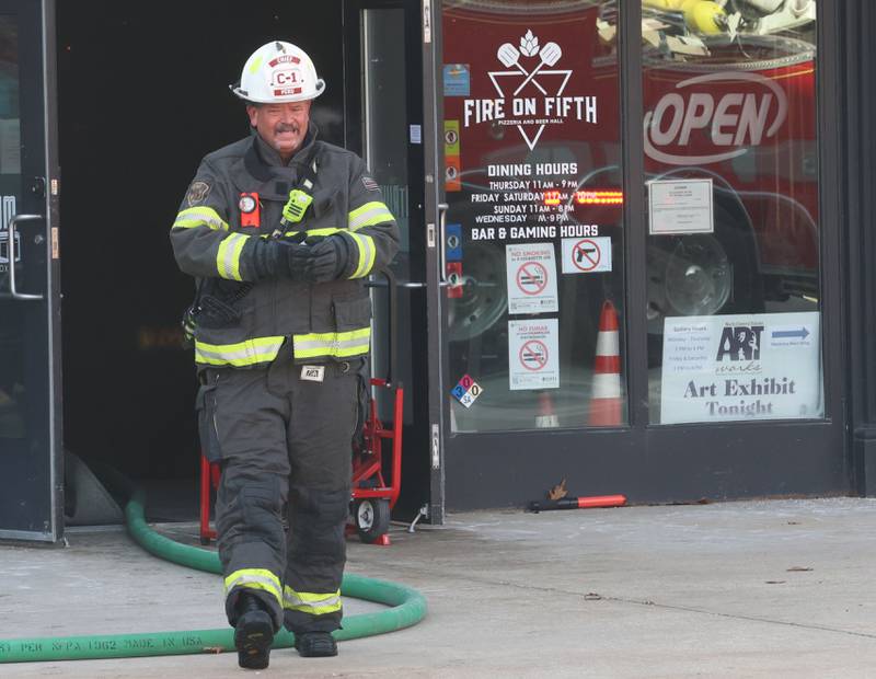Peru Fire Chief Jeff King, walks out of the Fire On Fifth entrance in the Westclox building on Tuesday, Jan. 20, 2026 in Peru. A working fire started in the storage room inside of Fire on Fifth. The fire started at 10a.m.  Fire departments from Utica, Oglesby Peru and La Salle all assisted on the scene. La Salle and Peru EMS were also dispatched. The entire Westclox building was evacuated. Two employees were transported by ambulance for smoke inhalation. A smoke detector inside Star Union Spirits triggered an alarm, prompting a fast response from firefighters.