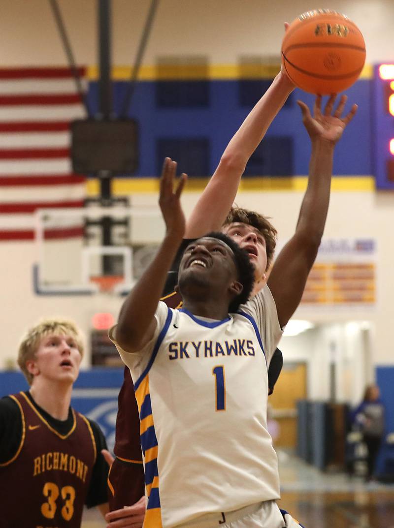 Johnsburg's Jarrel Albea has his shoot blocked by Richmond-Burton's Gavin Radmer during the IHSA Class 2A Johnsburg Regional Championship boys basketball game on Friday, February, 27, 2026, at Johnsburg High School.