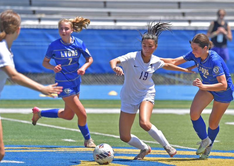 Downers Grove North’s Elle Edwards (19) tries to shake off Lyons Township’s Aoife Griffin (right) during their Class 3A Lyons Regional final on May 23, 2026 at Lyons Township High School in LaGrange.