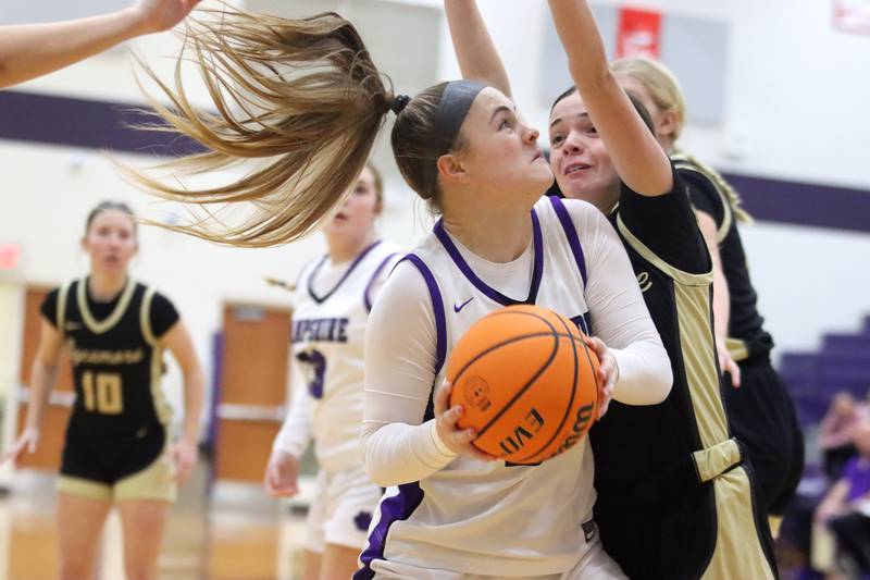 Hampshire’s Chloe Van Horn works under the hoop against Sycamore in varsity girls basketball on Friday, Jan. 3, 2025, at Hampshire High School in Hampshire.