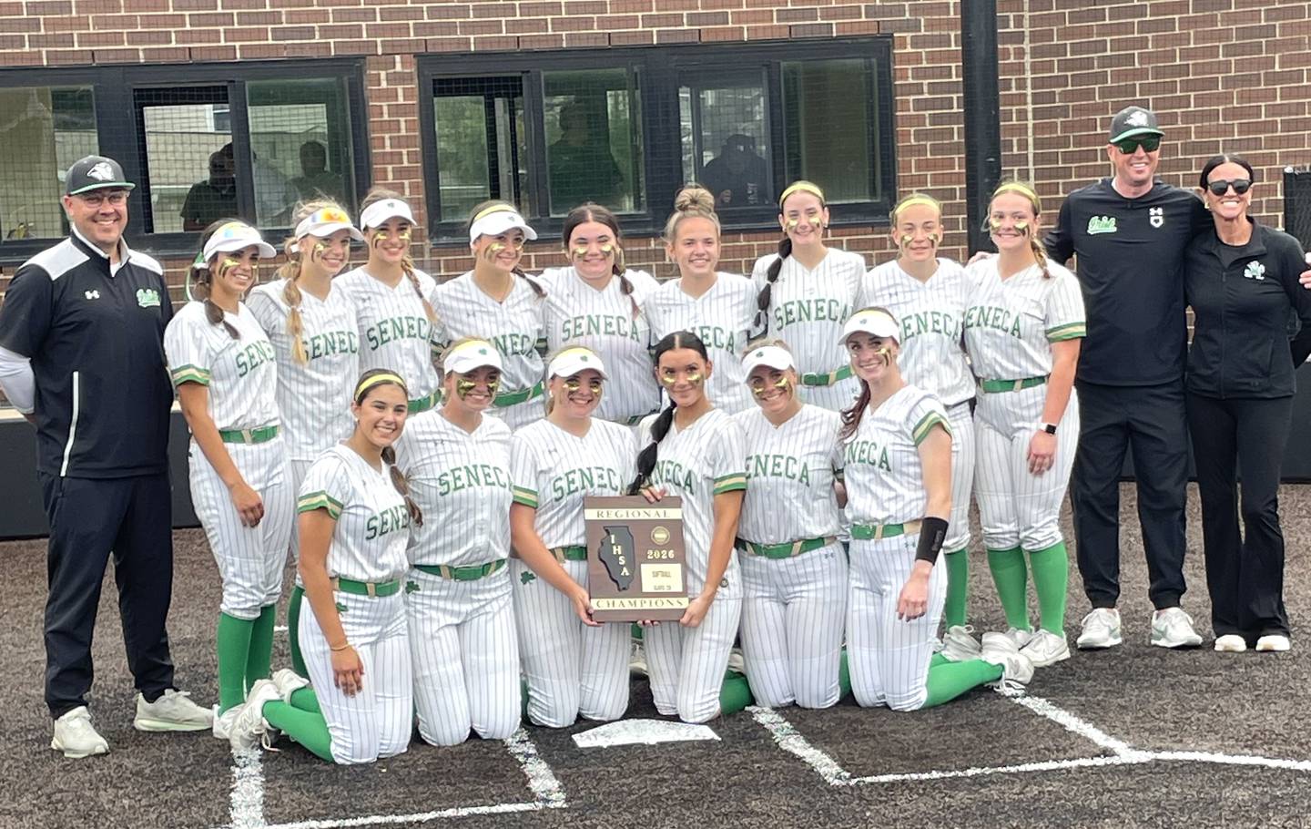 The Seneca softball team poses with its freshly won Class 2A regional championship plaque Friday, May 22, 2026, at Seneca.