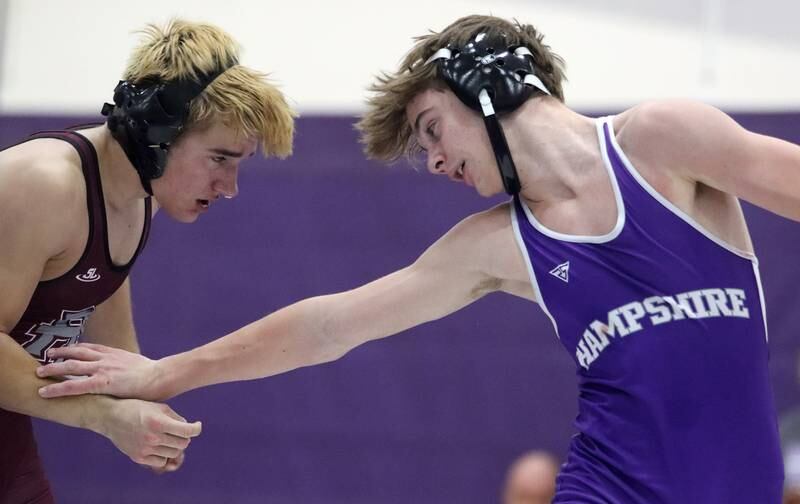 Hampshire’s William Randle-Zeglis, right, evades Prairie Ridge’s Andrew Cioper at 144 pounds in varsity wrestling on Thursday, Dec. 5, 2024 at Hampshire High School in Hampshire.