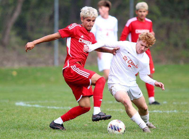 Dundee-Crown’s Sebastian Sanchez,left, battles St. Charles East’s Carter Newell in IHSA Class 3A Regional Championship soccer at Dundee-Crown High School in Carpentersville on Saturday, October 25, 2025.