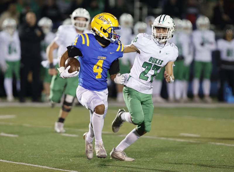 Lyons' Anthony Pearson (4) runs the ball during the varsity football first-round 8A playoff game between York and Lyons Township on Friday, Oct. 31, 2025 in Western Springs, IL.