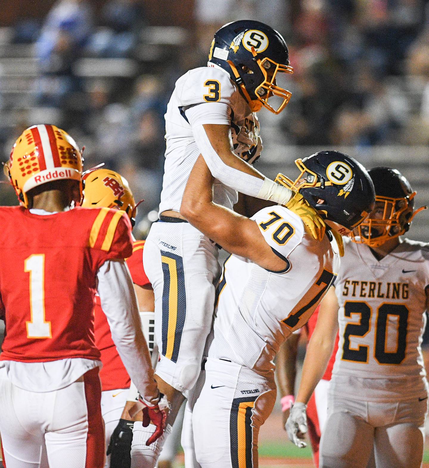 Sterling's Antonio Tablante (3) and Alejandro Arellano (70) celebrate a touchdown against Rock Island during their game at Almquist Field Friday, Oct. 8, 2021, in Rock Island.