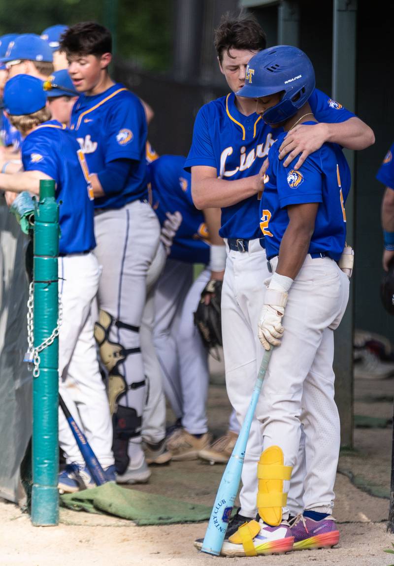 Lyons Township pitcher Tucker King embraces teammate Blake Ragsdale before Ragsdale’s at bat during a game between Downers Grove North in Downers Grove on Monday, May 12, 2025.