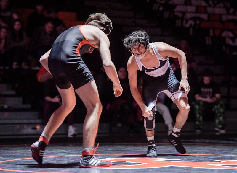 St. Charles East’s Liam Aye and Marian Central’s Anthony Alanis wrestle at 120 pounds during a match in St. Charles on Wednesday, December 20, 2023.