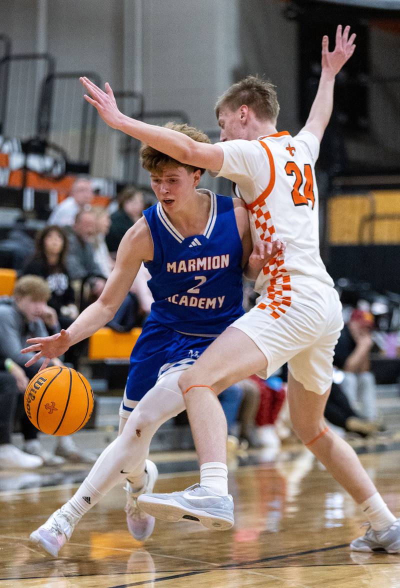 Marmion Academy guard Caden Anderson drives the lane during a game against St. Charles East High School on Saturday, Jan. 4, 2025.