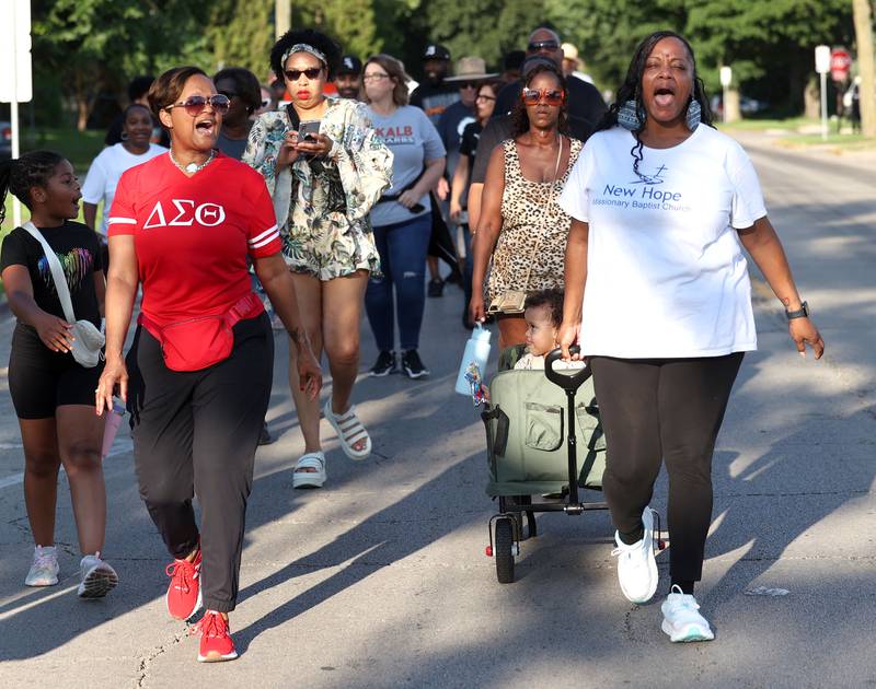 Marchers chant slogans as they make their way through the walk Friday, July 18, 2025, during the DeKalb Peace Walk and Rally. The event, which featured a march, food vendors and music, was held to encourage the community to work together against gun violence.