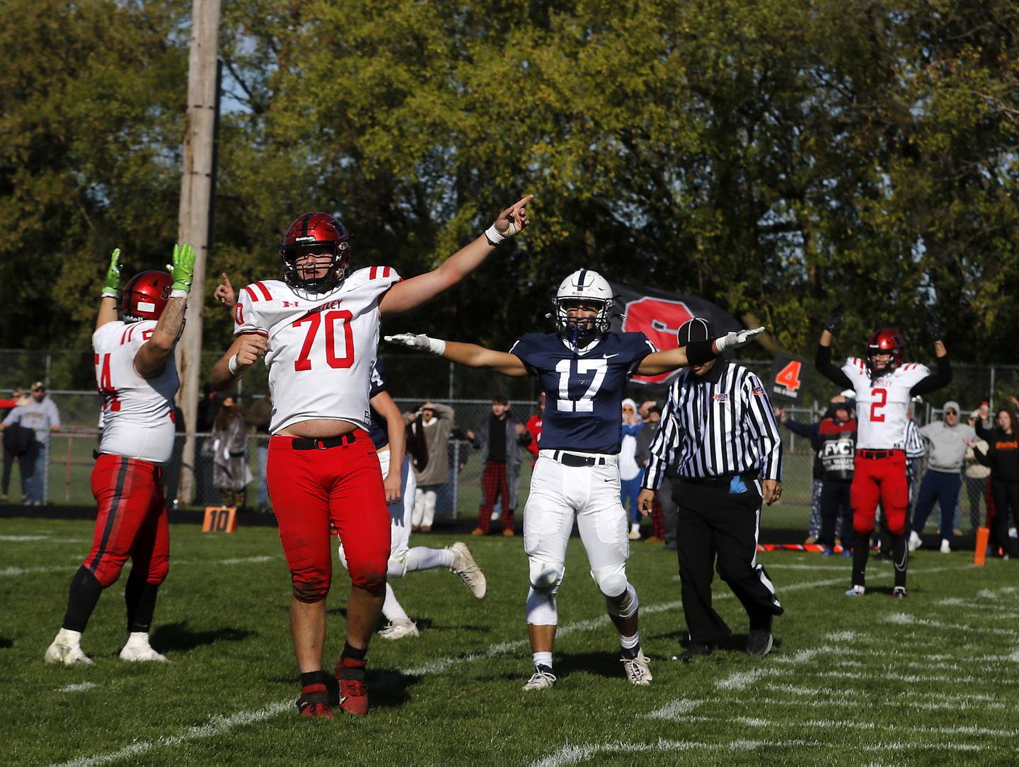 Huntley's Cam Mueller and Cary-Grove's Gavin Henriques argue for their desired outcome of a two-point conversion during a Fox Valley Conference football game on Saturday, Oct. 7, 2023, at Cary-Grove High School.