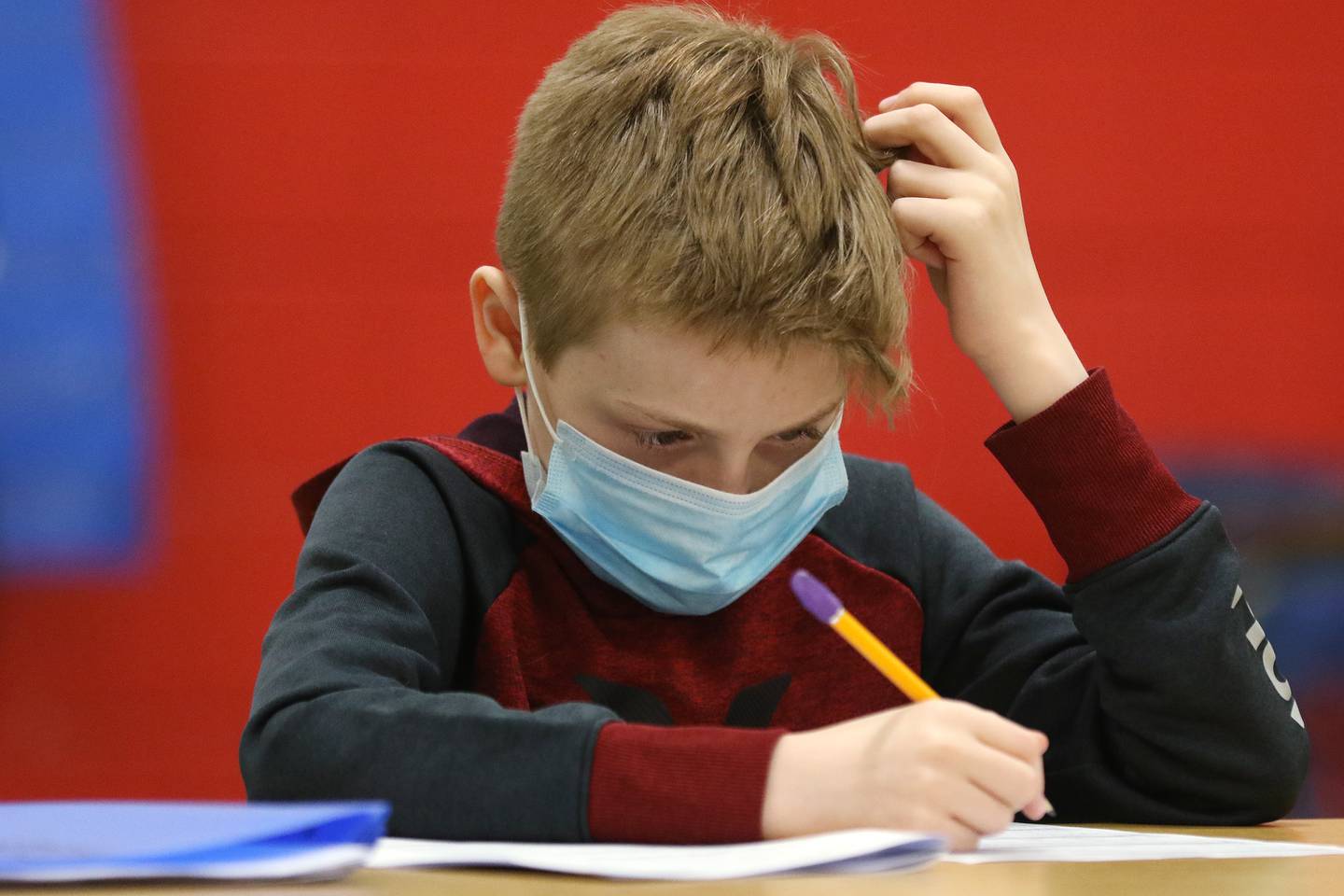 In this file photo from Wednesday, March 24, 2021, Terrence Criscione, a second grade student at Grant Elementary, works on his homework in an after school homework help program at Marengo Community Middle School in Marengo.