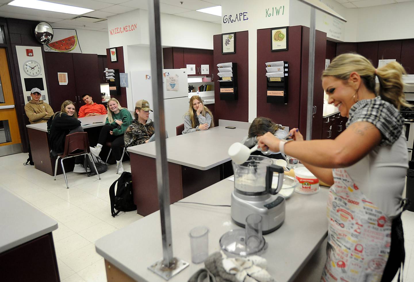 Teacher Suzanne Johnson show students how to make pie crust Tuesday April 19, 2022, during a foods class at Richmond-Burton High School. She works in the bake shop and coaches.